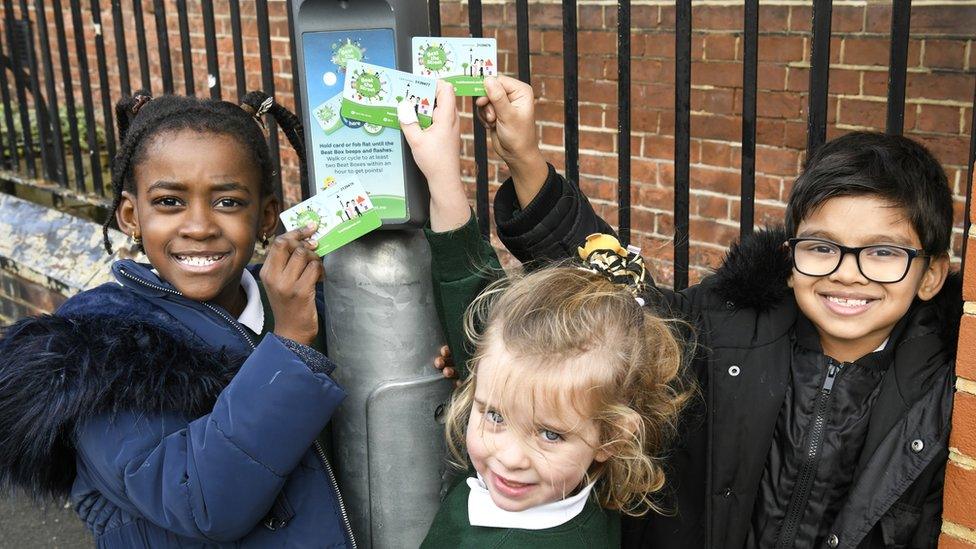 Primary school children tapping their cards against beat boxes