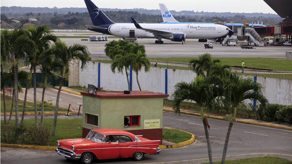 Blue Panorama and KLM aircrafts are seen as a taxi drives out of a parking lot at Havana"s Jose Marti International Airport February 15, 2016