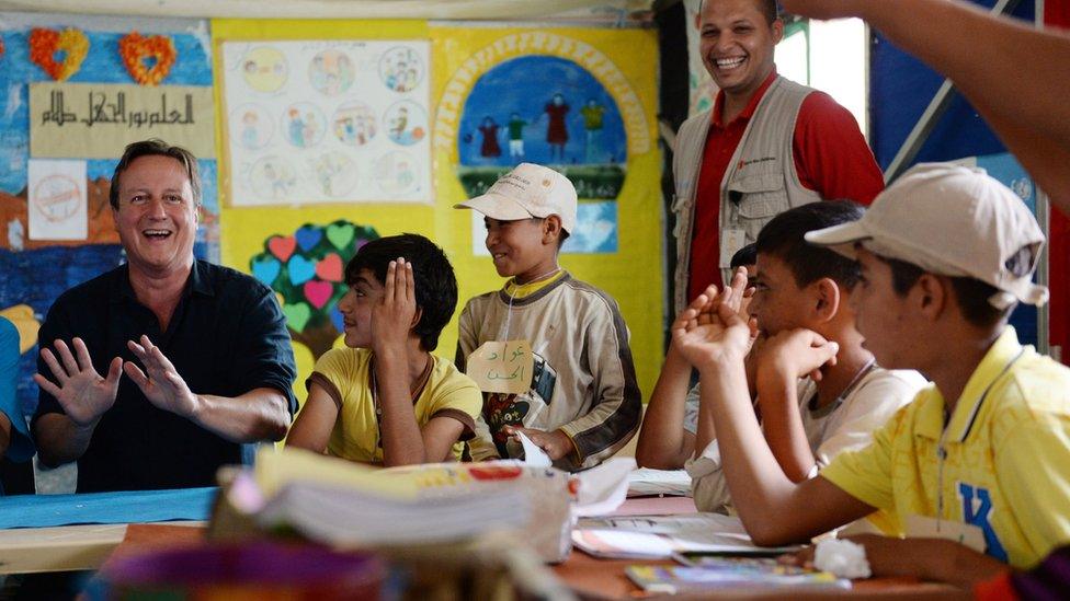 Prime Minister David Cameron meets refugee children and teenagers at a refugee camp in Jordan