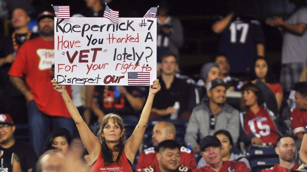 A fan protests against Kaepernick's refusal to stand for the national anthem