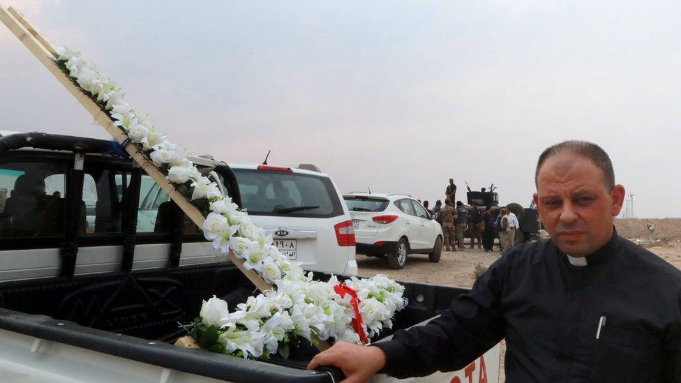 Father Paul Thabet Habib with a flower cross