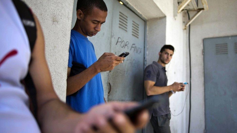 Cubans use mobile phones in Havana, 1 April 16