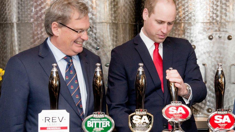 Prince William pulls a pint of Brains with Brains chairman John Rhys a few years ago