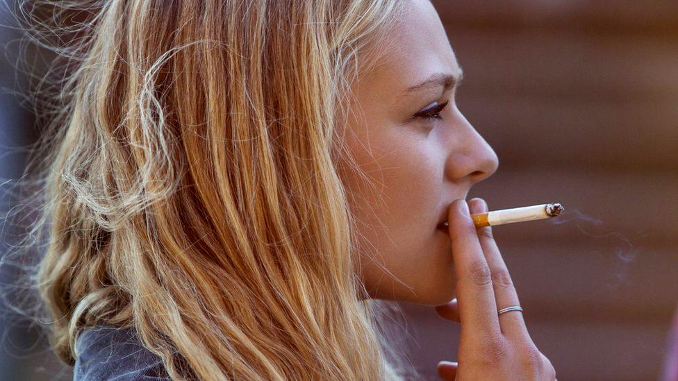 Blonde pistillate   smoking cigaret  - banal  photo