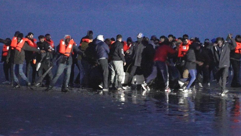 Migrants attempt to board boat