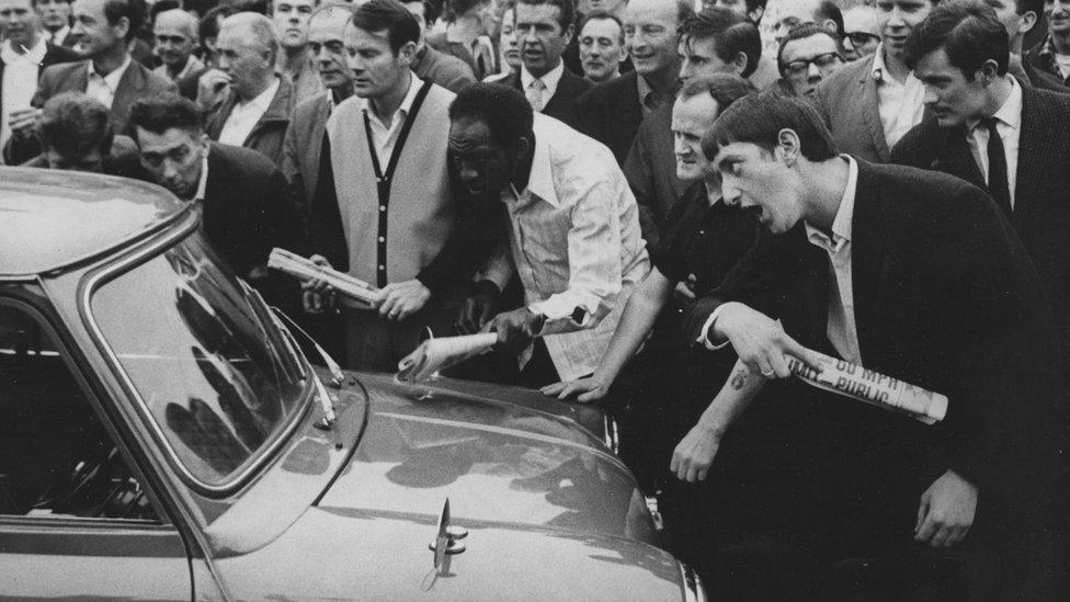 Vauxhall workers out on strike try to prevent a worker from crossing their picket line in Luton, 1967