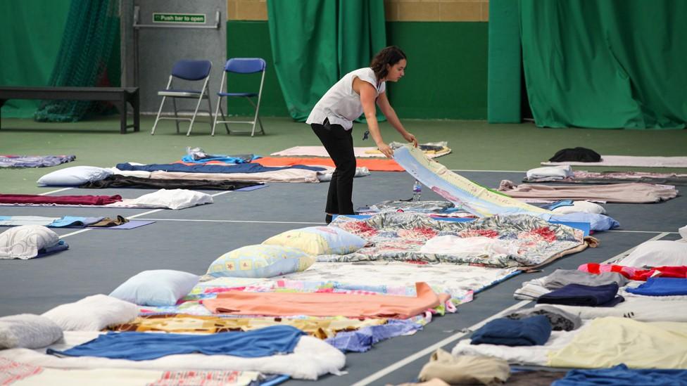 Setting out temporary beds in the Westway Sports & Fitness centre