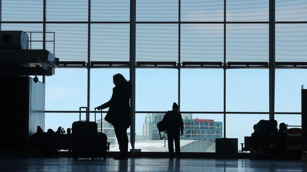 A photo of passengers at Toronto Pearson International Airport