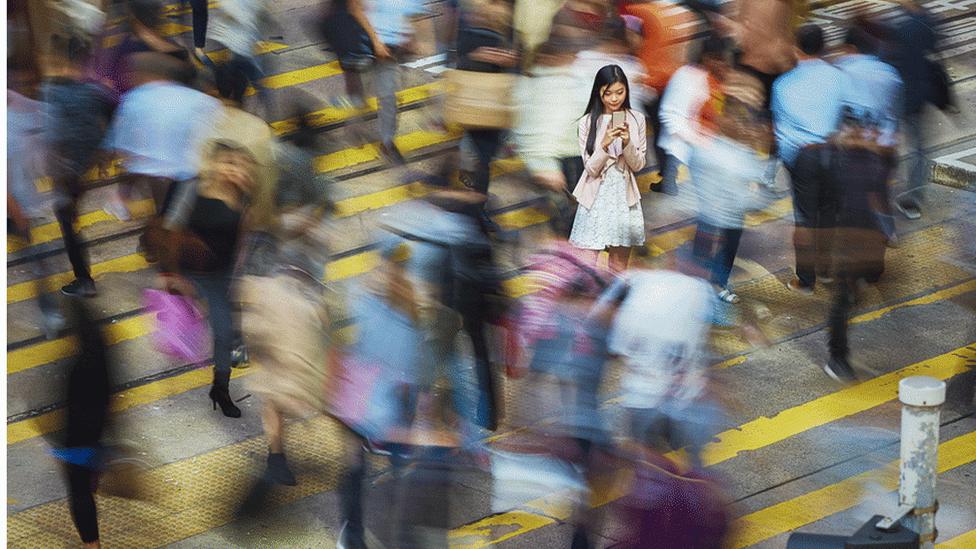 Woman in a crowd on phone