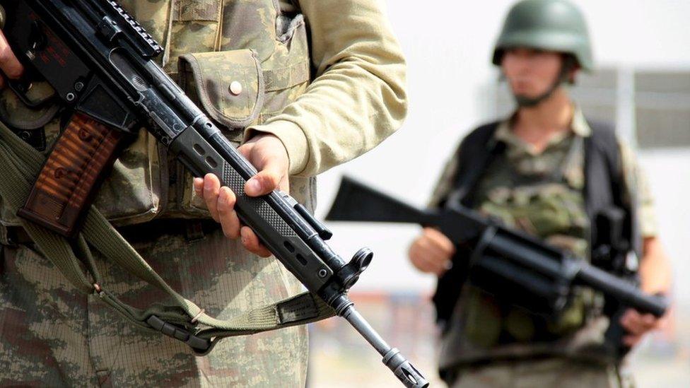 The Turkish army guards a road leading to Cizre