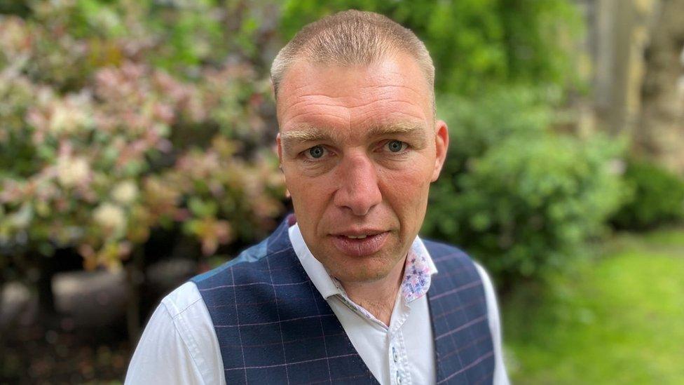 Dorset Police Federation chairman James Dimmack wearing a light blue shirt and a dark blue waistcoat