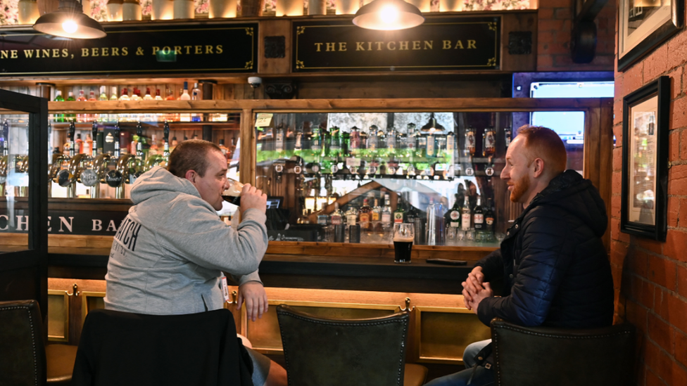 Two men drinking beer