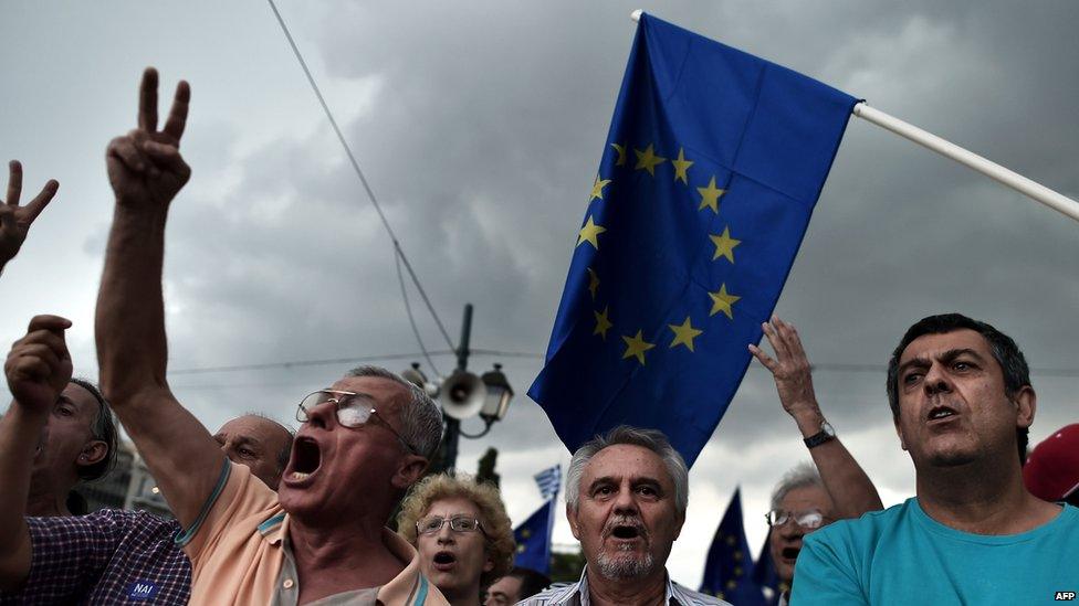 Pro-euro protesters hold European Union flags during a demonstration in front of the parliament in Athens