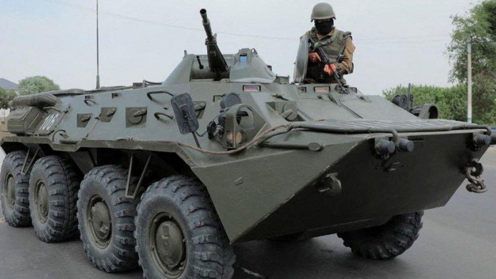 An Uzbek service member guards a street in Nukus, capital of the north-western Karakalpakstan region, Uzbekistan July 3, 2022.