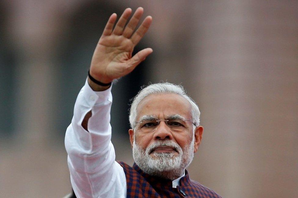 India"s Prime Minister Narendra Modi waves to his supporters as he arrives to address them during an election campaign meeting ahead of Gujarat state assembly elections, in Ahmedabad, India, December 3, 2017.