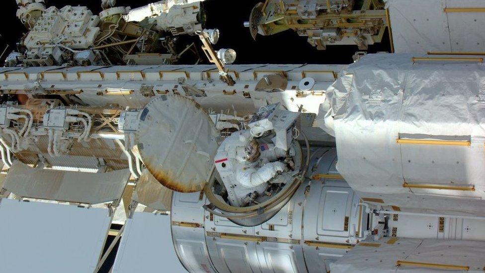 Tim Kopra coming through the airlock to the outside of the space station