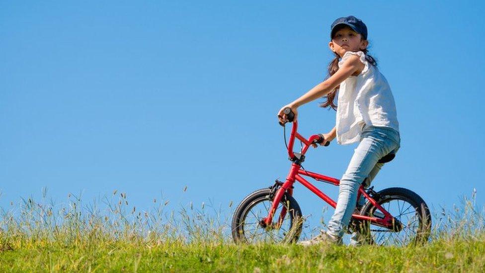 girl-on-a-bike-on-a-hill