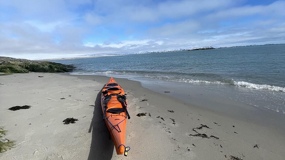 Mike Keen's orange kayak on the beach in Greenland