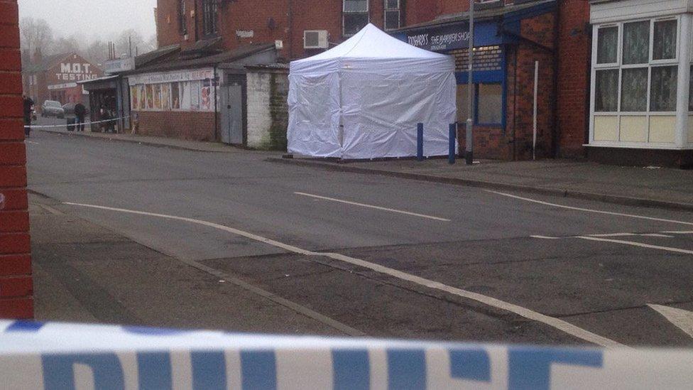 White tent in front of a barber shop