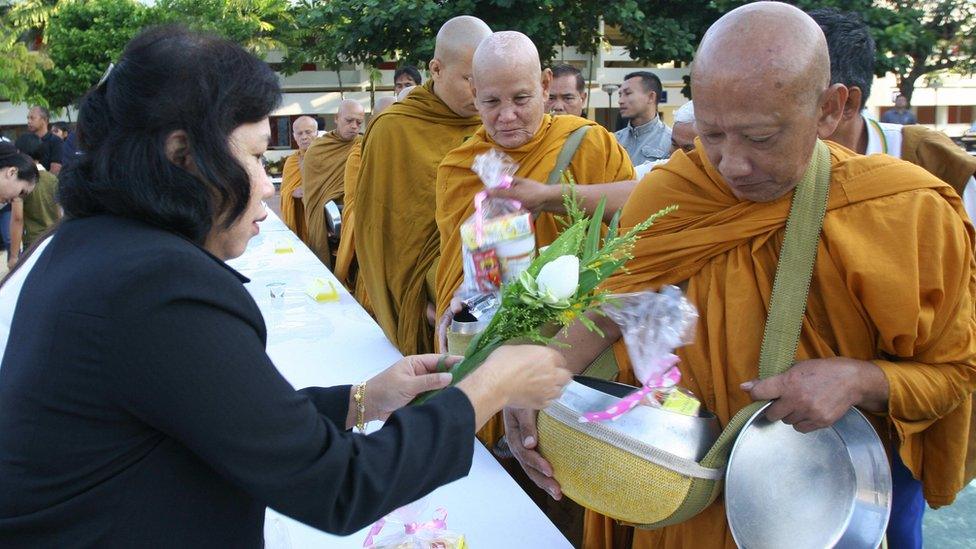 Thai monks receiving food offerings