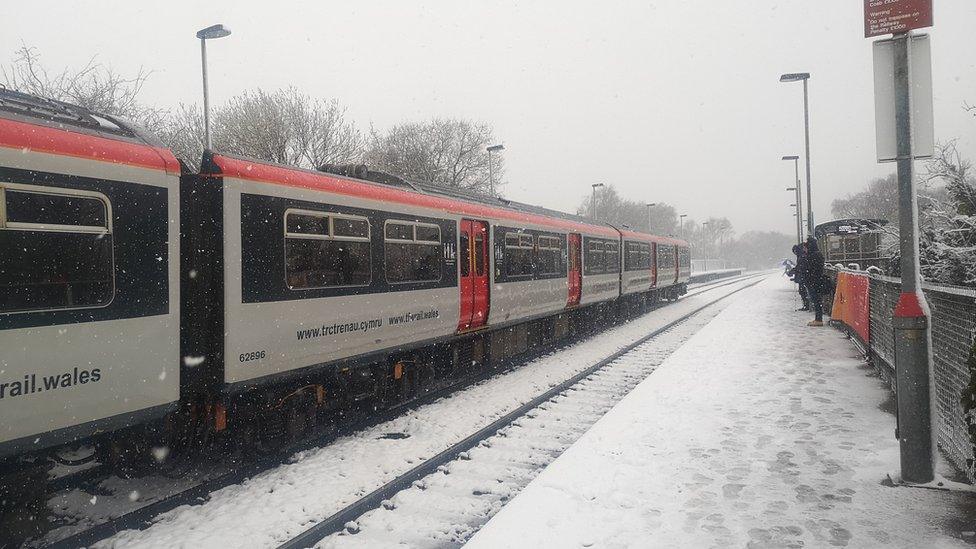 A train travelling in the snow at Heath High level train station in Cardiff