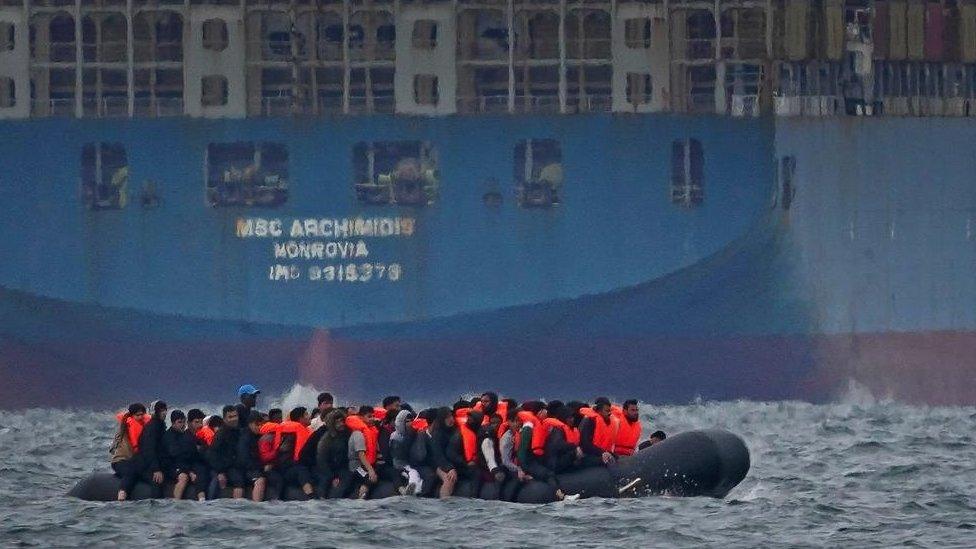 A group of people thought to be migrants crossing the Channel in a small boat traveling from the coast of France and heading in the direction of Dover, Kent