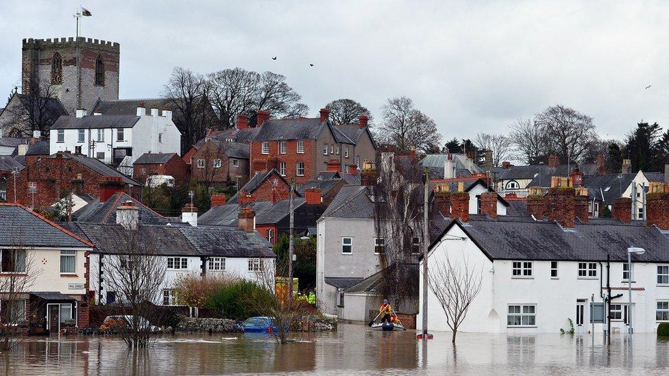 St Asaph flooding in November 2012, showing town with cathedral in background and a boat rescue