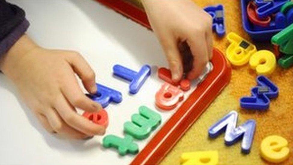 Child playing with plastic letters