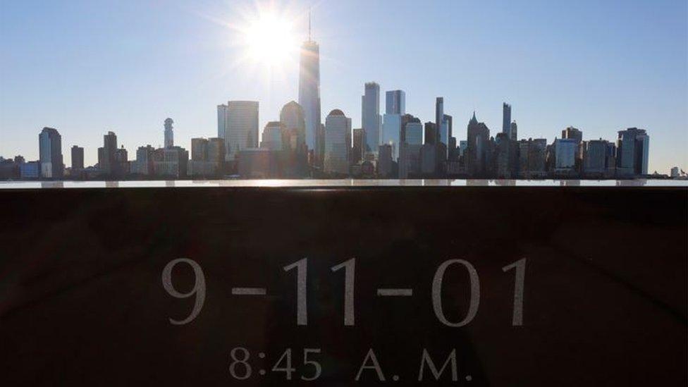 A memorial stone overlooking Manhattan with One World Trade Center at its heart