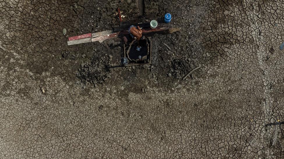 Fisherman and trader Raimundo Silva do Carmo, 67, fetches water from a well, Lago do Puraquequara lake, Manaus, Brazil