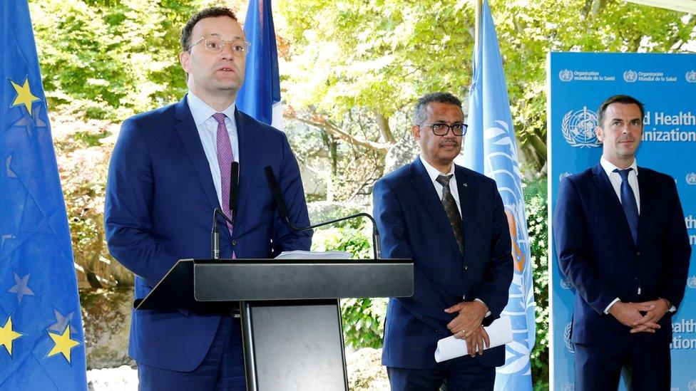 German Health Minister Jens Spahn speaks to reporters, with WHO Director General Tedros Adhanom Ghebreyesus and French Health Minister Olivier Veran in Geneva, Switzerland (25 June 2020)