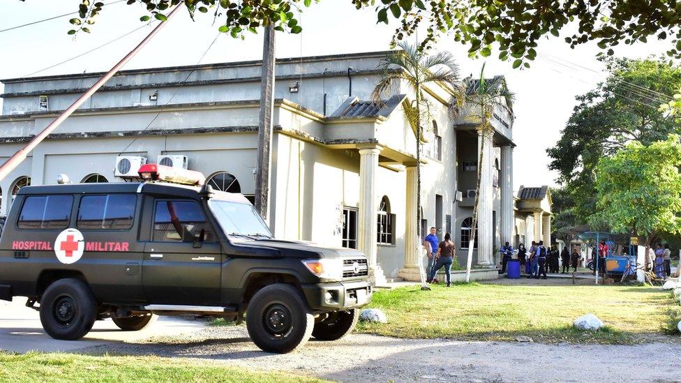 A Honduran military police ambulance sits next to the headquarter of the Justice Palace in El Progreso