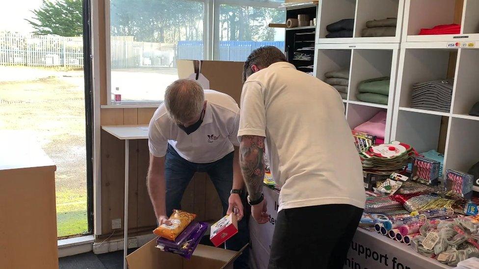 Dave Viner and volunteer packing gift hamper