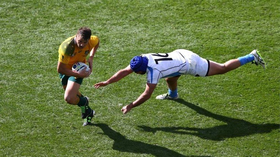 Drew Mitchell of Australia beats Nicolas Klappenbach of Uruguay during the 2015 Rugby World Cup Pool