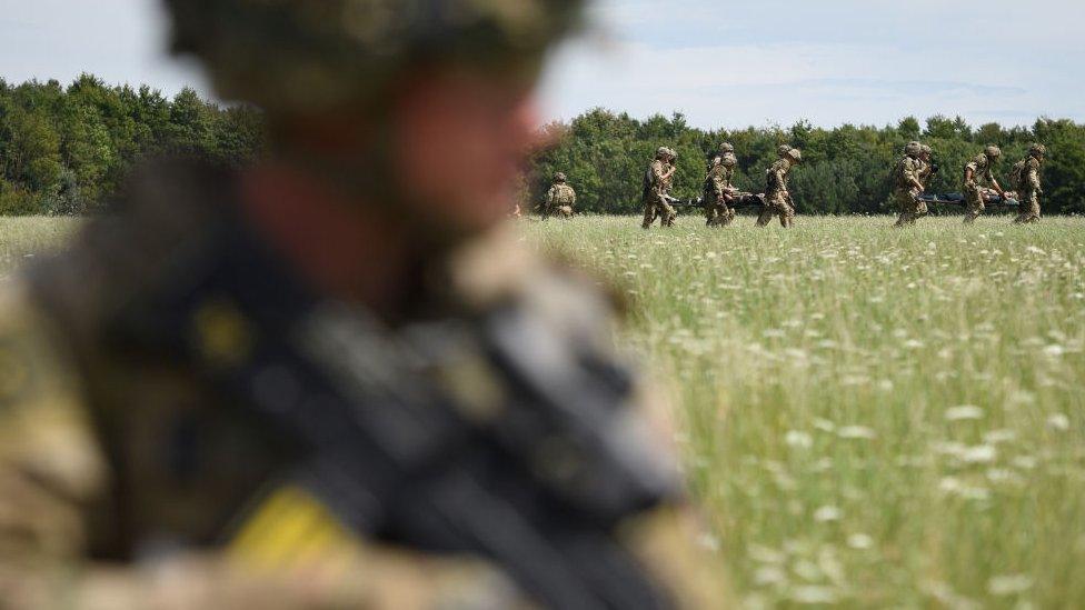 Private Patrick Rodgers of the Anglian Regiment, 2nd Battalion awaits the arrival of a Chinook helicopter for a medical evacuation during a military exercise on Salisbury Plains on July 23, 2020 near Warminster, England.