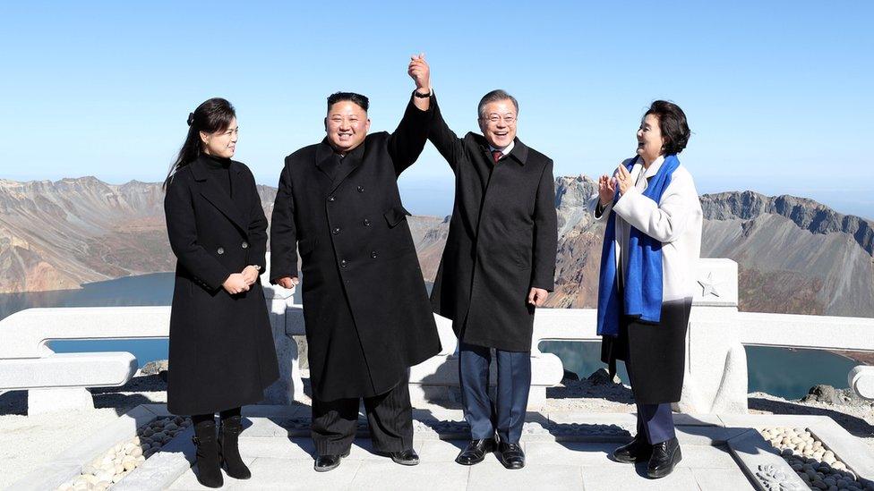 President Moon Jae-in and North Korean leader Kim Jong Un pose for photographs on the top of Mt. Paektu