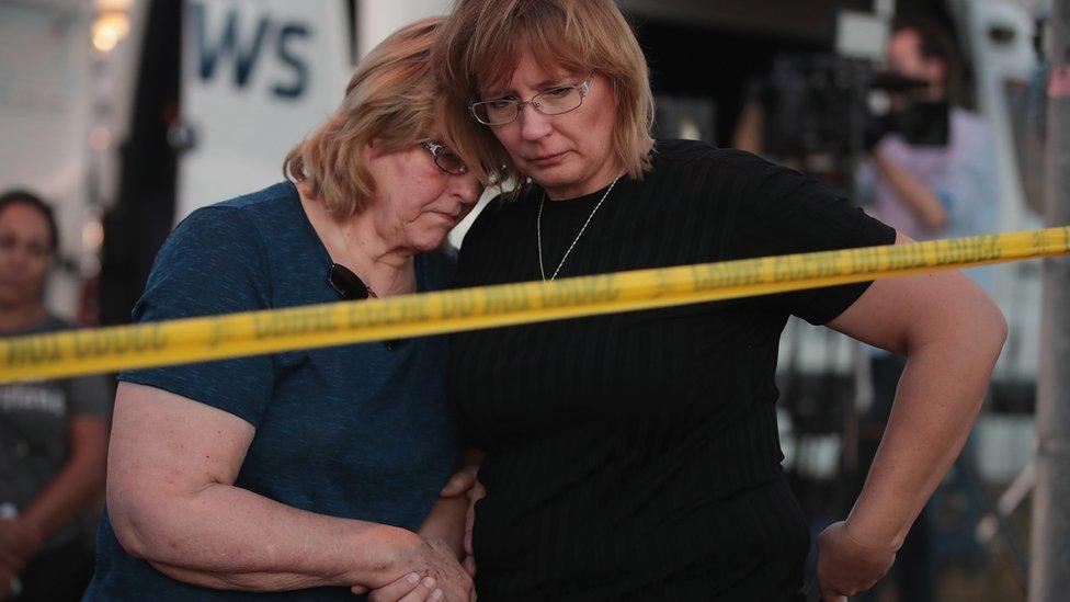 two women stand behind police line after texas shooting