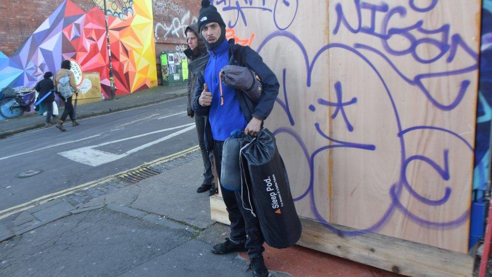 Man with a sleeping pod and sleeping bag