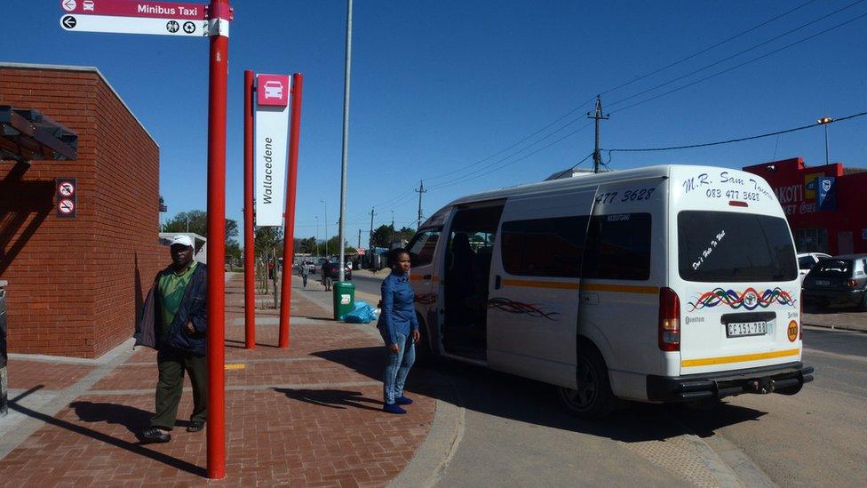 A minibus taxi waits for passengers on 24 August 2014 outside South Africa's first taxi rank to be considered 'green' in Wallacedene, about 35 km from the centre of Cape Town.