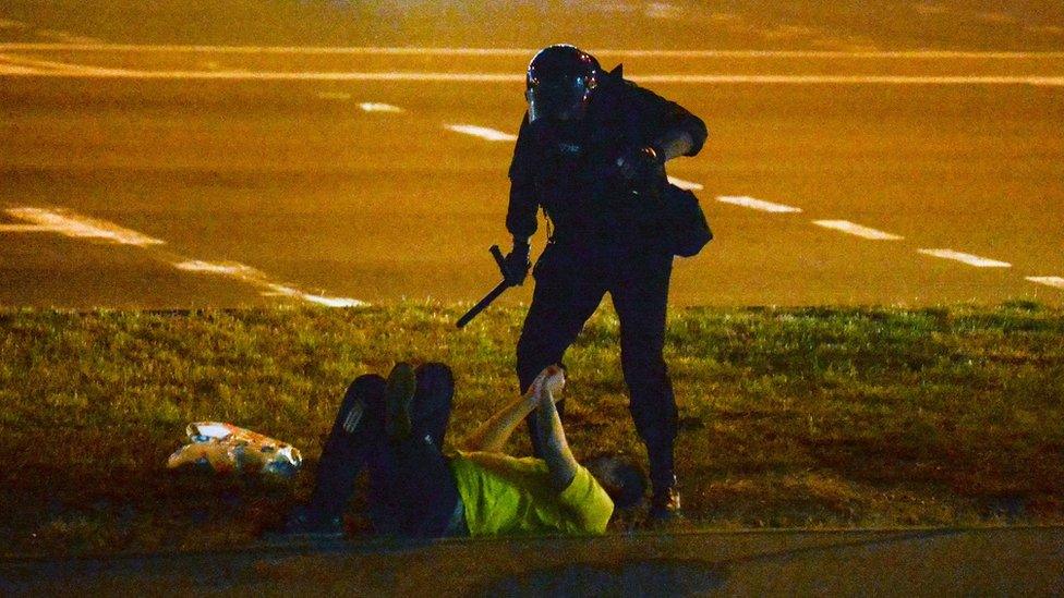 Police officers detain a protester during a rally after the presidential election, in Minsk, Belarus