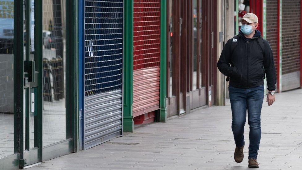 man walking in mask