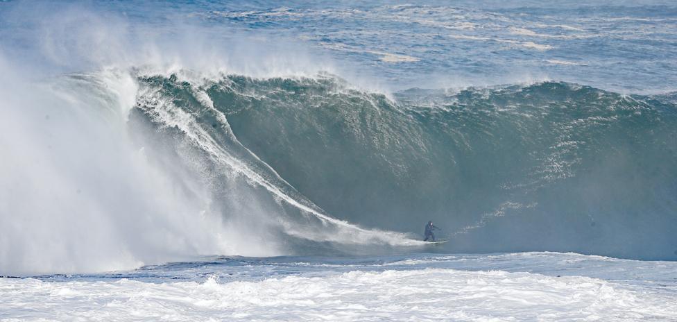 Surfers riding high waves in Mullaghmore, County Sligo