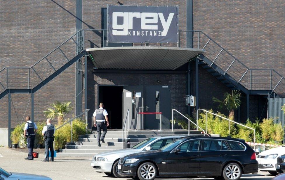 Police officers stand at the door of the night club "Grey" in Konstanz, Germany, on 30 July 2017. According to a police report, a 34-year-old man shot at several people inside the club in the early morning.