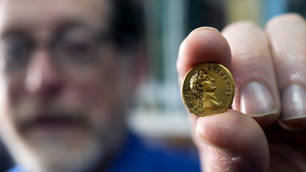 Man holds small gold in his fingers