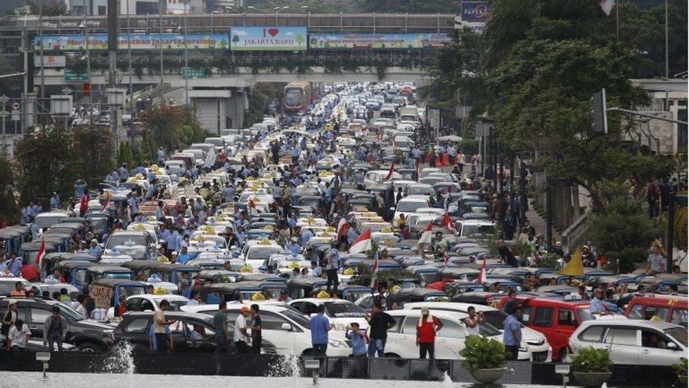 Taxis block a road in Jakarta, Indonesia (22 March 2016)