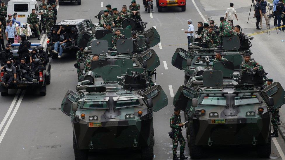 Indonesian soldiers man armoured vehicles as they guard near the site where an attack occurred in Jakarta, Indonesia Thursday, Jan. 14, 2016.