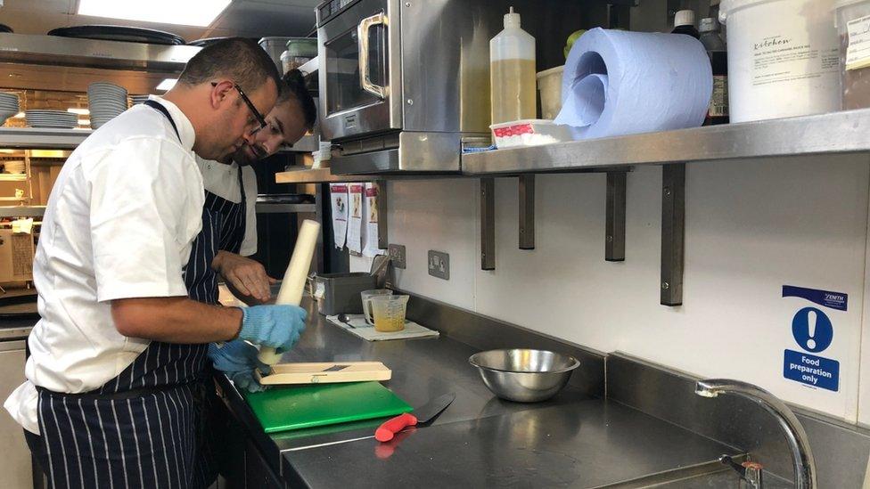 Two men working in a restaurant kitchen