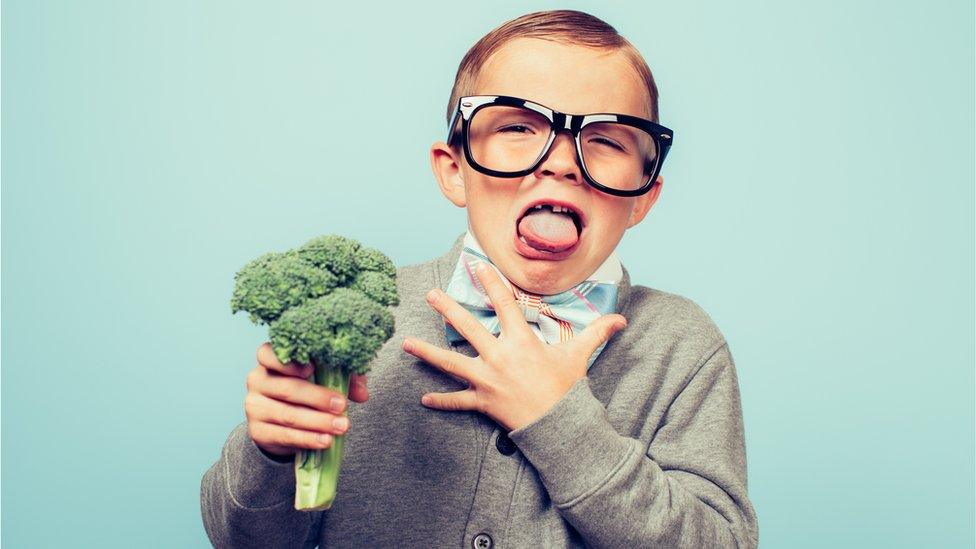 Boy holding broccoli