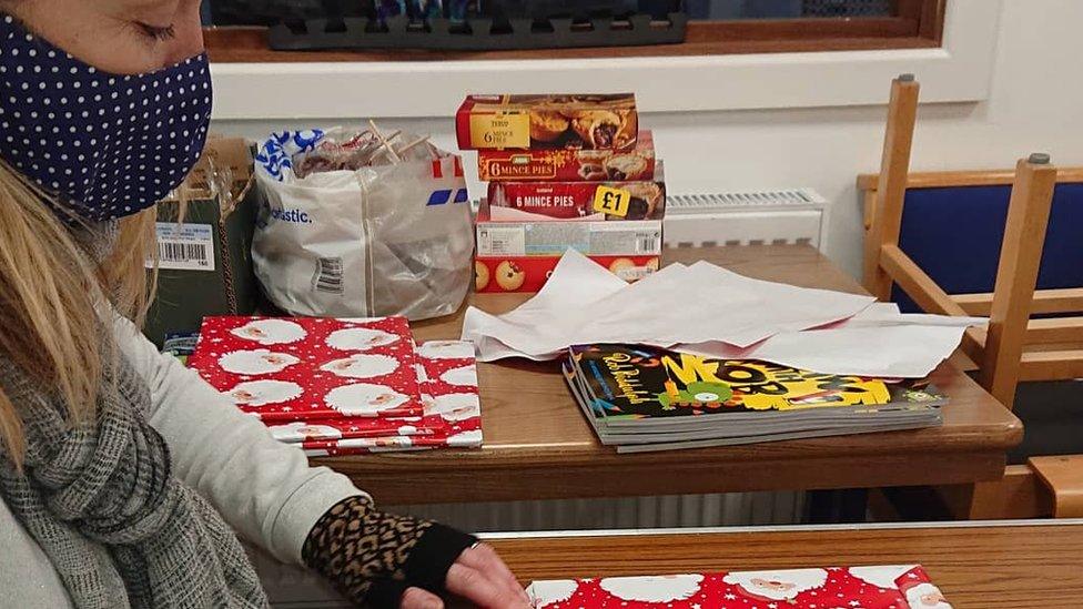 Volunteer wrapping presents