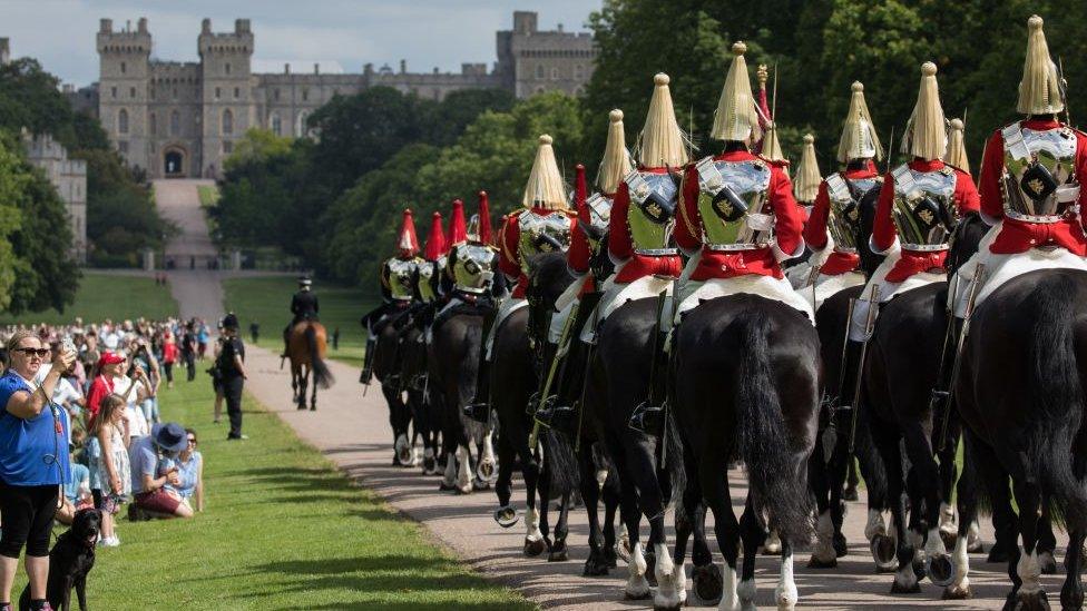 the Household Cavalry Mounted Regiment proceed along the Long Walk to Windsor Castle